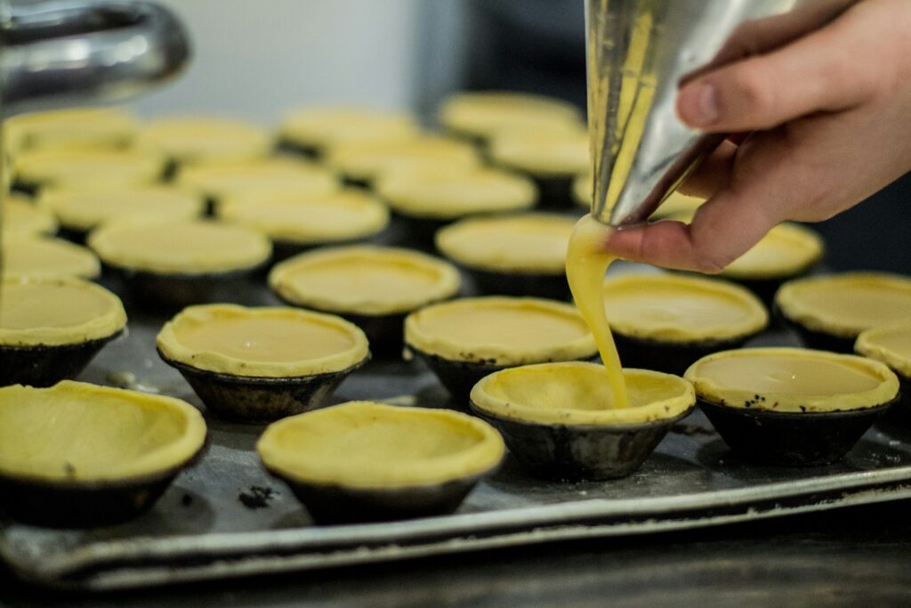 color image with photo of the process of production of the pastéis de nata, Lisbon, Portugal